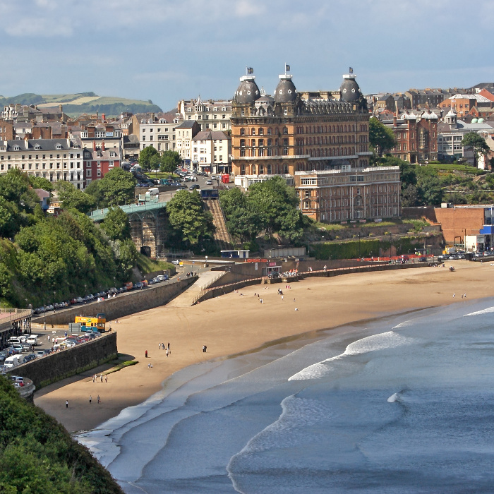 Scarborough is an English town by the sea, popular in Summertime for holidays.